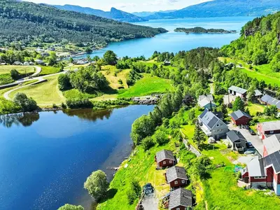 an aerial view of a village next to a lake at Apartment Samlen Vasselgård by Interhome in Herand