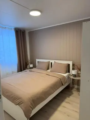a bedroom with a large bed with two pillows at Kirkevegen apartment in Brumunddalen