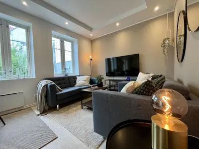 a living room with a couch and a tv at Exclusive apartment in historical house, Bergen in Bergen