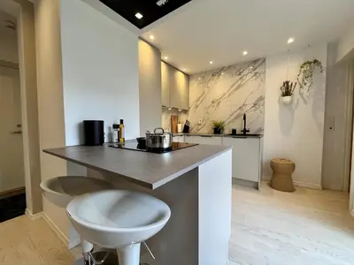 a kitchen with a island with a counter top at Exclusive apartment in historical house, Bergen in Bergen