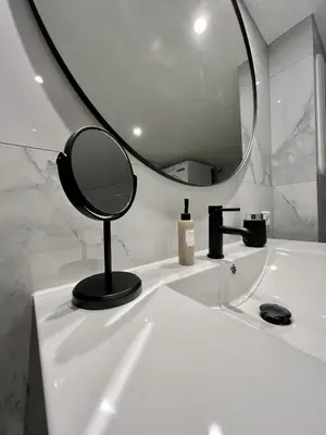 a bathroom with a mirror on a white sink at Exclusive apartment in historical house, Bergen in Bergen