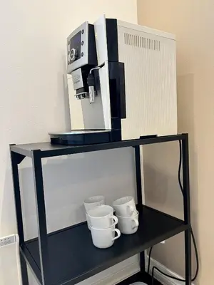 a coffee machine on top of a shelf with cups at Exclusive top apartment, central location in Bergen in Bergen