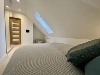 a bedroom with a bed and a skylight at Exclusive top apartment, central location in Bergen in Bergen