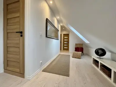 a hallway with a staircase with a mirror and a door at Exclusive top apartment, central location in Bergen in Bergen