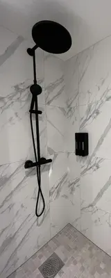 a black stool in a room with a marble wall at Beautiful apartment in Bergen in Bergen