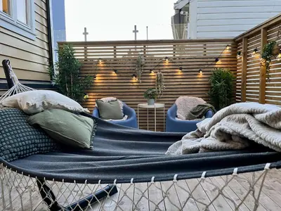 a hammock with pillows and a blanket on a patio at Beautiful apartment in Bergen in Bergen