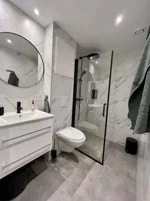 a bathroom with a toilet and a sink and a shower at Beautiful apartment in Bergen in Bergen