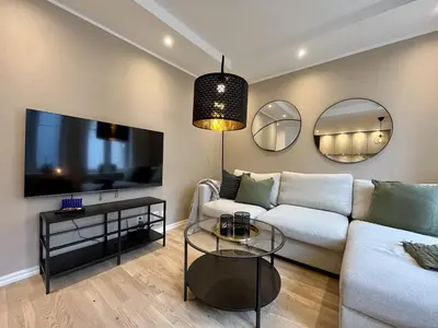 a living room with a couch and a tv at Beautiful apartment in Bergen in Bergen