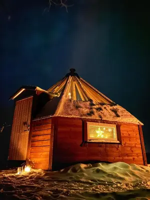 a small house with a roof on top of snow at Hessdalen Ufocamp in Vårhus