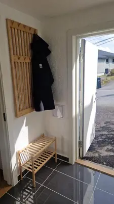 a door open to a room with a bench outside at Modern condominium in Bergen