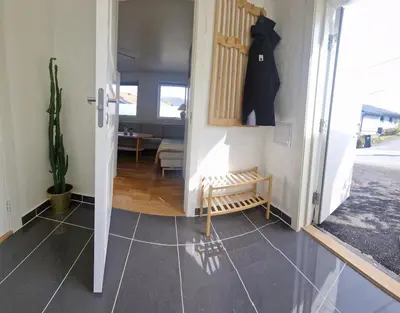 a hallway with a door open to a living room at Modern condominium in Bergen