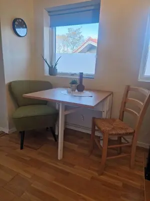 a desk with a chair and a window and a table at Modern condominium in Bergen