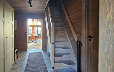 a wooden staircase in a room with a door at Lovely Home In Eggedal With Wifi in Eggedal