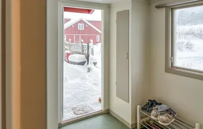 a hallway with a large window and a red barn at Cozy Home In Oppdal With House A Mountain View in Oppdal