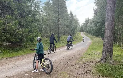 a group of people riding bikes on a dirt road at Cozy Home In Oppdal With House A Mountain View in Oppdal