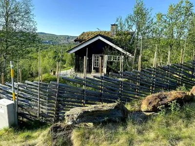 a wooden fence in front of a small building at Lovely Family Cabin Near Ski Stadium In Beitostølen in Beitostøl