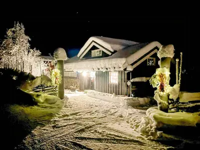 a house covered in snow at night at Lovely Family Cabin Near Ski Stadium In Beitostølen in Beitostøl