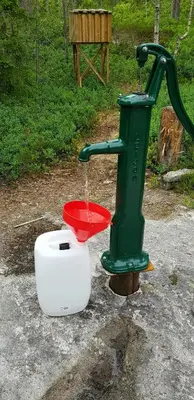 a green water fountain with a red bowl at Cabin At The Foot Of Andersnatten in Engar
