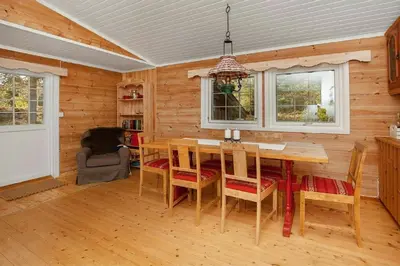 a dining room with a table and chairs at Cabin At The Foot Of Andersnatten in Engar