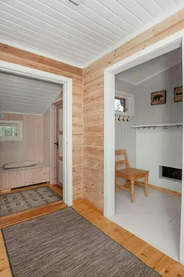 an open door to a room with a chair and a table at Cabin At The Foot Of Andersnatten in Engar