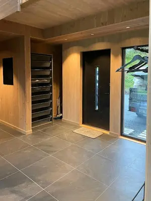 a large room with a door and a tiled floor at Lovely Cabin With Hot Tub Near Syningtoppen in Torpo