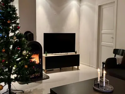 a living room with a christmas tree and a television at Koselig sentrumsleilighet - Nær Bryggen in Bergen
