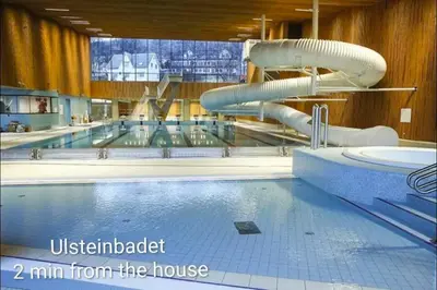 a large swimming pool with a water slide at Lundenhuset 1917 - historic house in the heart of Ulsteinvik in Ulstein
