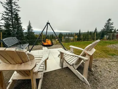 two chairs and a swing and a fire pit at Modern Cabin With Ski-Inout Near Birken Trails in Rena