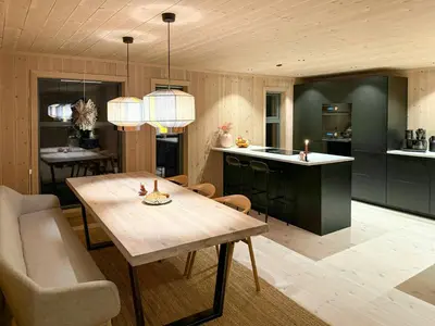 a kitchen with a wooden table and a dining room at Modern Cabin With Ski-Inout Near Birken Trails in Rena