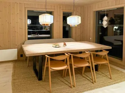 a dining room with a wooden table and chairs at Modern Cabin With Ski-Inout Near Birken Trails in Rena