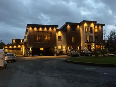 a large building with cars parked in a parking lot at Penthouse apartment 2 bedrooms 70 m2 in Verdal