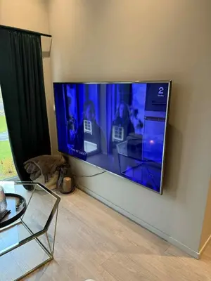 a large flat screen tv hanging on a wall at Penthouse apartment 2 bedrooms 70 m2 in Verdal
