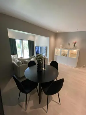 a living room with a table and chairs and a couch at Penthouse apartment 2 bedrooms 70 m2 in Verdal