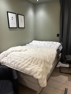 a bed in a bedroom with two pictures on the wall at Penthouse apartment 2 bedrooms 70 m2 in Verdal