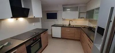 a kitchen with a sink and a stove top oven at Rooms in easy accessible new apartment near Stave church in Bergen