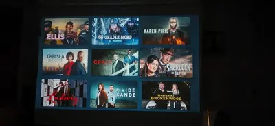 a bunch of movies are on a tv screen at Rooms in easy accessible new apartment near Stave church in Bergen