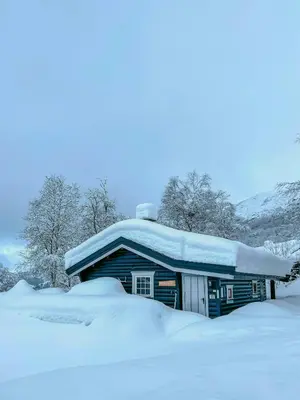 a house covered in snow with snow on top of it at Timber Cabin With Ski-In Access At Solheisen in Hemsedal