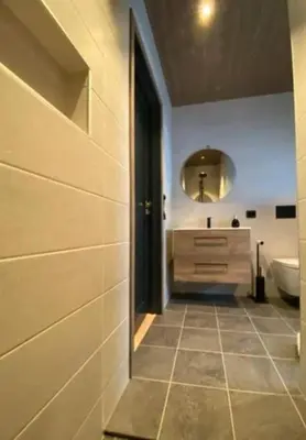 a bathroom with a tub and a sink and a mirror at Cabin With Ski Inout Near Stryn Alpine Resort in Stryn