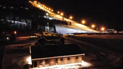 a ski slope at night with a building and lights at Cabin With Ski Inout Near Stryn Alpine Resort in Stryn