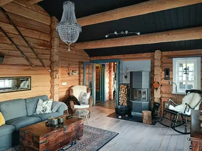 a living room with a couch and a table at Log Cabin Near Muen And Myafallene in Venabygd