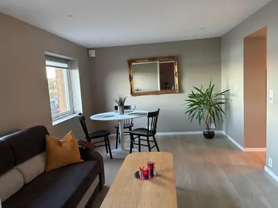 a living room with a couch and a table at Alesund apartment fantastic view in Ålesund
