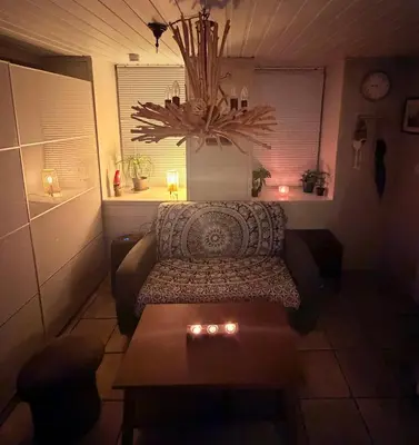 a living room with a couch and a table at Cozy little apartment at the back of Bryggen in Bergen