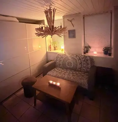 a living room with a couch and a table at Cozy little apartment at the back of Bryggen in Bergen