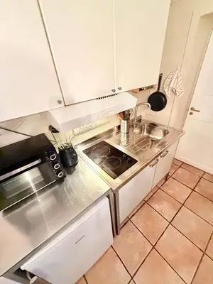 a kitchen with a sink and a stove at Cozy little apartment at the back of Bryggen in Bergen