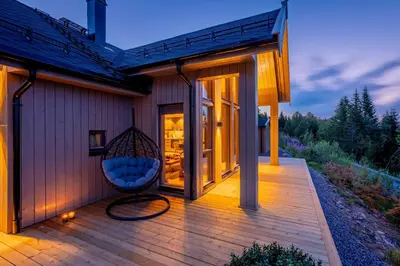 a porch of a house with a swing at Viking Lodge Panorama-Norefjell in Noresund