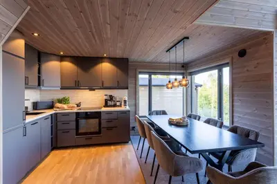 a kitchen and dining room with a table and chairs at Viking Lodge Panorama-Norefjell in Noresund