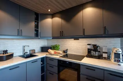 a kitchen with black cabinets and a counter top at Viking Lodge Panorama-Norefjell in Noresund