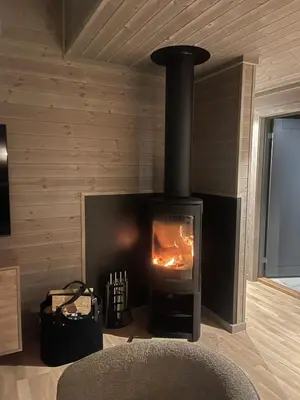 a fireplace in a room with a stove at Viking Lodge Panorama-Norefjell in Noresund