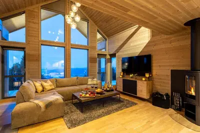 a living room with a couch and a tv at Viking Lodge Panorama-Norefjell in Noresund