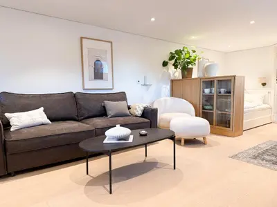 a living room with a couch and a table at Soft Stay Apartment in Bergen